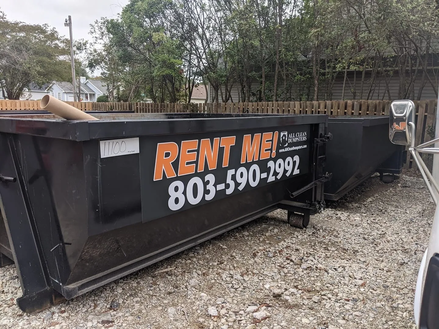 A dumpster with the words rent me ! on it.