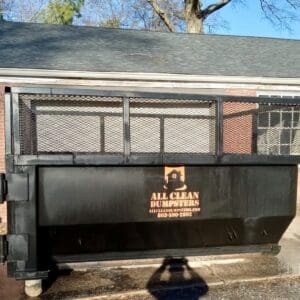A dumpster sitting in front of a house.